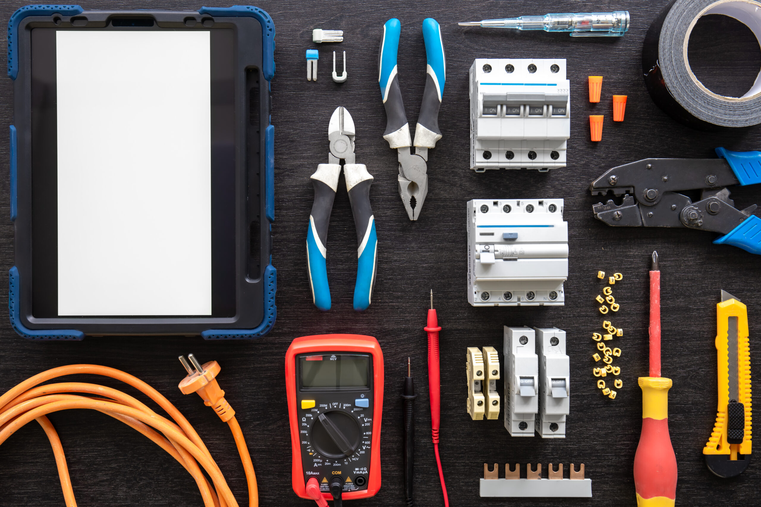 Different electrical tools on wooden background, flat lay.